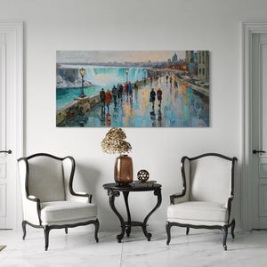 May include: An oil painting depicts a waterscape with figures walking along a pathway. The artwork, with a long rectangular shape, hangs above a small table and two armchairs. The color palette includes blues, greens, and warm tones.