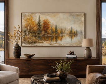 May include: A rectangular landscape painting featuring a forest with autumn-colored trees in shades of orange, yellow, and green reflected in a calm lake. The artwork is displayed in a thin wooden frame and mounted on a neutral-colored wall.