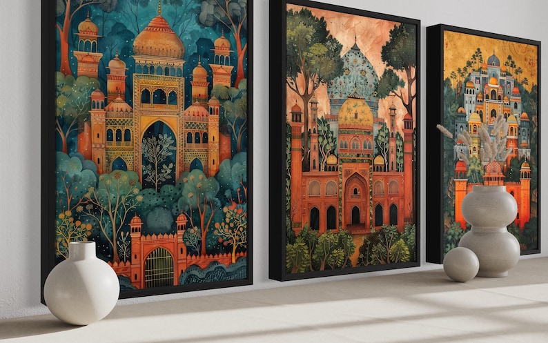 three framed paintings of ornate, colorful buildings with intricate architectural details, displayed on a wall.