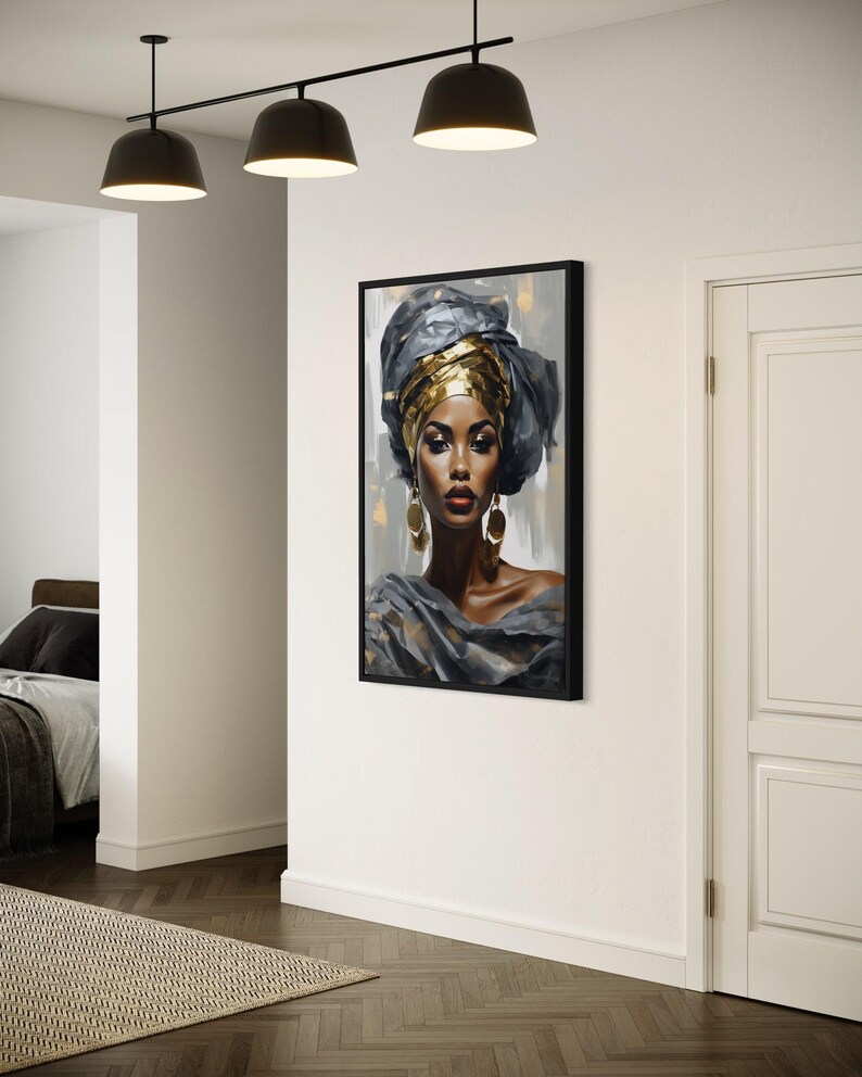 a large framed portrait of a woman with a headdress, hanging on a white wall in a room with a wooden floor.