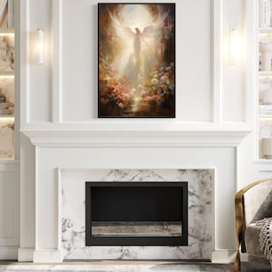 a living room with a fireplace, a bookshelf, and a painting of an angel. The painting is hanging above the fireplace, which is located in the center of the room. The bookshelf is on the left side of the room, and the fireplace is on the right side. The room has a modern and elegant design, with white walls and marble accents.