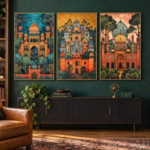 May include: A set of three rectangular wall art prints featuring detailed architectural illustrations of ornate palaces with domes and arches, rendered in vibrant shades of orange, blue, and green, displayed in thin gold frames on a dark wall.