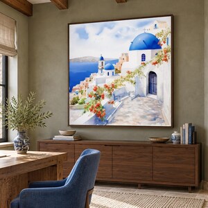 May include: A square wall art print featuring a Mediterranean coastal scene with white buildings, iconic blue domes, and vibrant orange flowers cascading over a stone path, all set against a bright blue sea and sky background.