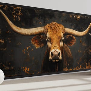 a large painting of a bull with long horns, displayed on a wall. The bull is the central focus of the painting, with its distinctive horns prominently featured. The painting is framed and placed on a white wall, with two white vases positioned on either side of it.