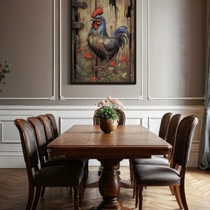 a dining room with a wooden table and six chairs around it. A framed painting of a rooster is hanging on the wall above the table.