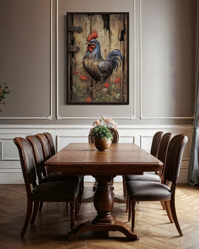 a dining room with a wooden table and six chairs around it. A framed painting of a rooster is hanging on the wall above the table.