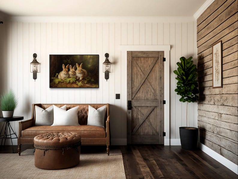 a cozy living room with a brown leather sofa, a wooden door, and a painting of three rabbits on the wall. The room has a rustic, country-style decor with wooden walls and a wooden floor.