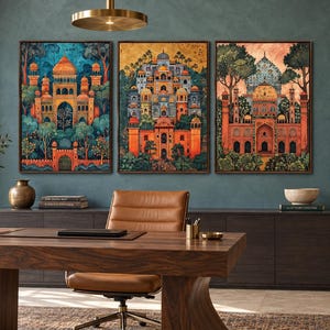 May include: A set of three rectangular wall art prints featuring intricate architectural illustrations of palaces with domes and arches, rendered in vibrant shades of orange, blue, and gold, displayed in dark brown frames on a teal wall.