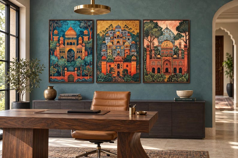 May include: A set of three rectangular wall art prints featuring intricate architectural illustrations of palaces with domes and arches, rendered in vibrant shades of orange, blue, and gold, displayed in dark brown frames on a teal wall.