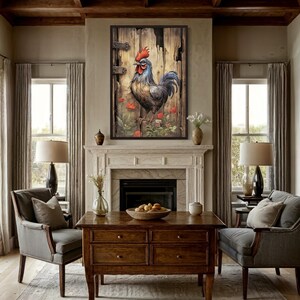 a cozy living room with a large wooden coffee table in the center, surrounded by two gray armchairs. Above the coffee table hangs a framed painting of a rooster in a rustic wooden frame, with a weathered wooden door in the background. The room features a fireplace, a window with curtains, and a wooden floor.