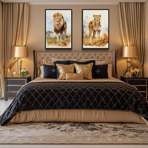a luxurious bedroom with a large bed, gold and black bedding, and two framed paintings of lions on the wall above the bed.