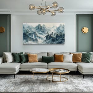 a modern living room with a large white sectional sofa adorned with colorful throw pillows, a glass coffee table, and a large painting of mountains hanging on the wall.
