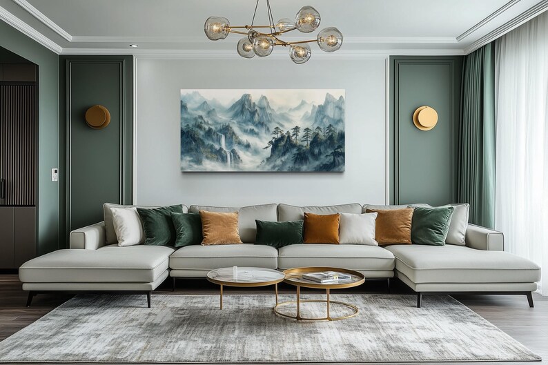 a modern living room with a large white sectional sofa adorned with colorful throw pillows, a glass coffee table, and a large painting of mountains hanging on the wall.