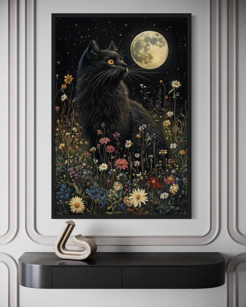 The image is a framed painting depicting a black cat sitting in a field of flowers and plants, with a full moon in the background.
