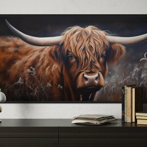 a large painting of a horned animal, likely a yak or a bull, with a dark background and a lighter background. The painting is displayed on a wall, and there is a lamp and some books on a table in front of it.