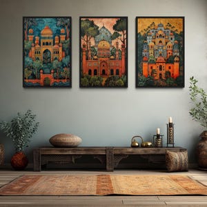 a living room with three framed paintings of Indian architecture hanging on the wall above a wooden coffee table. The room is decorated with various items, including potted plants, vases, and a rug, creating a cozy and inviting atmosphere.