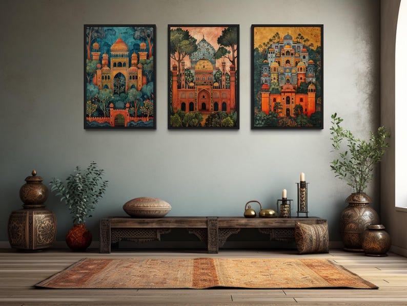 a living room with three framed paintings of Indian architecture hanging on the wall above a wooden coffee table. The room is decorated with various items, including potted plants, vases, and a rug, creating a cozy and inviting atmosphere.