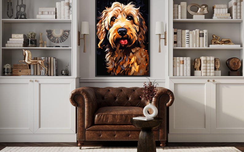a large, colorful painting of a dog's face hanging on a wall in a living room. The dog appears to be a golden retriever, with a playful expression. The room is decorated with white bookshelves, a brown leather armchair, and a wooden side table. The overall atmosphere of the room is cozy and inviting, with the dog painting being the focal point.