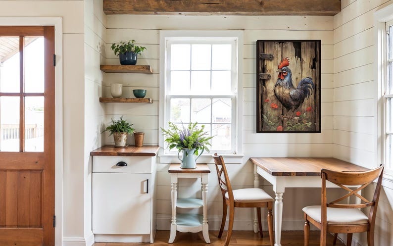 a cozy and rustic kitchen with a wooden table and chairs, a white cabinet, and a framed painting of a rooster on the wall.