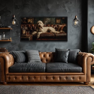 May include: A luxurious brown leather sofa with black cushions and tufted detailing. The room features a framed painting of a dog on a sofa, dark walls, and decorative lighting. A rug and wooden side table complete the scene.