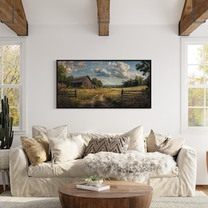 a cozy living room with a large window overlooking a rural landscape, featuring a barn and a field. The room is decorated with a white sofa, a wooden coffee table, and various potted plants, creating a warm and inviting atmosphere.