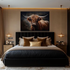 a luxurious bedroom with a large bed, dark bedding, and a framed painting of a Highland cow on the wall. The room has a modern and elegant design, with gold-colored lighting fixtures and a black headboard.
