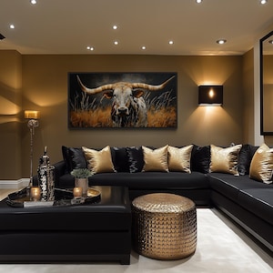 A luxurious living room with a large black sectional sofa, a coffee table, and a large framed painting of a bull on the wall. The room is decorated with gold accents, including a large mirror, a gold vase, and a gold-colored ottoman.