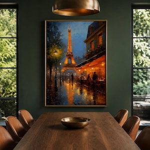 May include: A rectangular framed wall art print featuring an oil painting of the Eiffel Tower in Paris at night. The scene depicts a street with warm glowing lights, a cafe terrace, and reflections on a wet pavement under a deep blue evening sky.