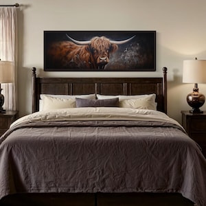 a bedroom with a large bed, wooden furniture, and a framed painting of a bull on the wall.