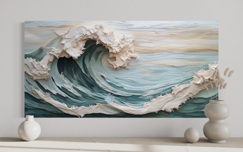 a large, intricately designed wave with a light blue-green color scheme, set against a white background. The wave appears to be made of paper or fabric, creating a visually striking and artistic representation of the ocean.