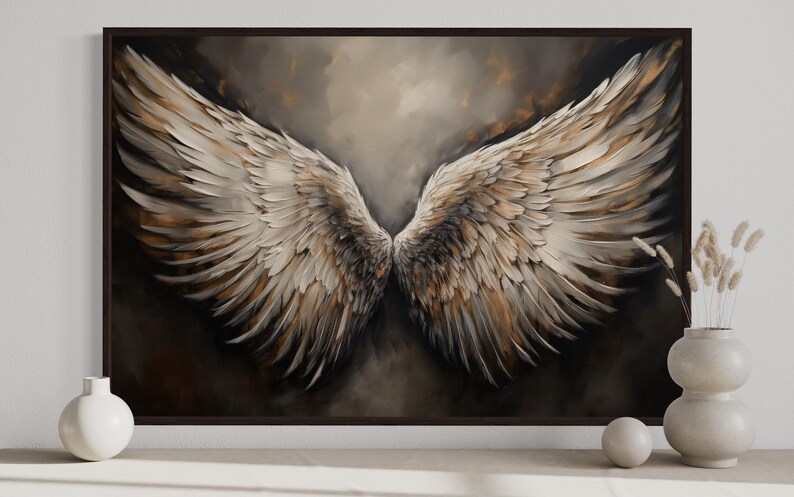 a large painting of a pair of angelic wings, with a dark background and a warm color palette. The painting is framed and displayed on a wall, with a vase of dried flowers and a small white sculpture placed next to it.
