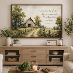 May include: A rectangular wall art print featuring a rustic barn in a grassy field with a dirt path and trees. The text reads: Commit to the Lord whatever you do, and He will establish your plans. PROVERBS 16:3. The print is framed in dark wood.