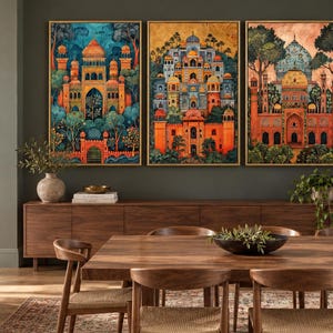 May include: A set of three rectangular wall art prints featuring intricate architectural structures with domes and arches in vibrant orange, blue, and gold tones, surrounded by stylized trees and foliage, each framed in a thin gold-coloured border.