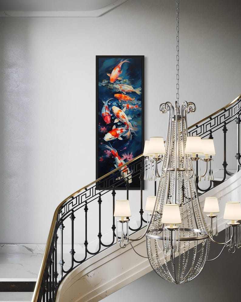 a staircase with a large, ornate crystal chandelier hanging from the ceiling, and a framed painting of colorful fish displayed on the wall above the staircase.