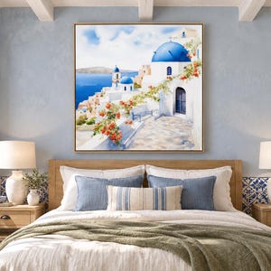 May include: A square wall art print featuring a Mediterranean coastal scene with white buildings, iconic blue domes, and vibrant orange bougainvillea flowers overlooking a deep blue sea under a bright, clear sky.