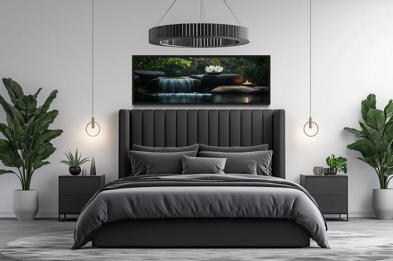 a modern bedroom with a large bed, a black headboard, and a framed landscape painting of a waterfall and flowers above it. The room is decorated with potted plants and has a minimalist, stylish design.