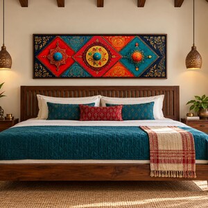 Puede incluir: Una estructura de cama de madera con una colcha acolchada color verde azulado, una manta con estampado crema y rojo, y cojines decorativos en verde azulado y rojo. Sobre la cama cuelga un arte mural rectangular con patrones geom&eacute;tricos vibrantes.
