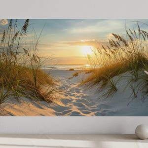 a serene beach scene with a path leading to the ocean, surrounded by tall grasses and a warm, golden sunset.