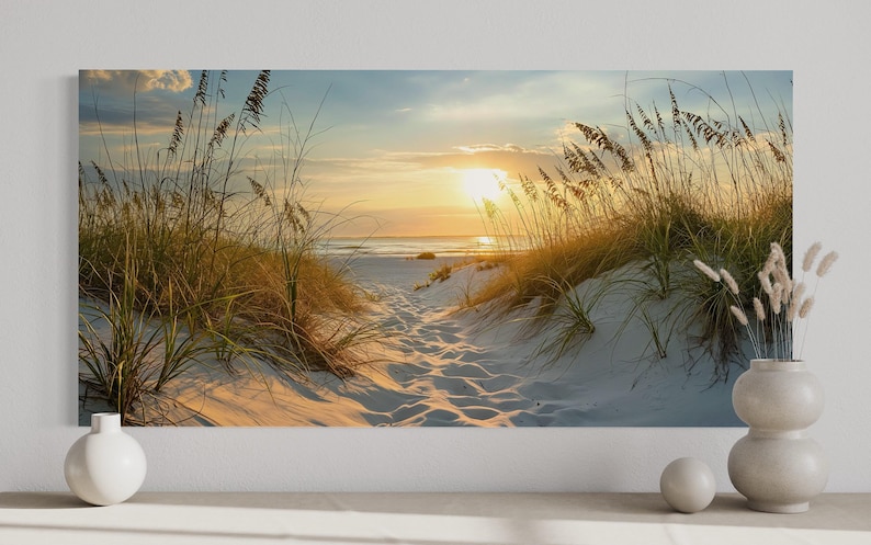 a serene beach scene with a path leading to the ocean, surrounded by tall grasses and a warm, golden sunset.