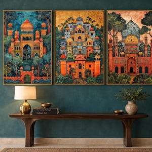 May include: A triptych of three framed wall art prints featuring detailed architectural illustrations of palaces with domes and arches in vibrant orange, blue, and gold tones, set against lush green trees and foliage in a stylised landscape.