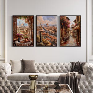 A luxurious living room with a white tufted sofa, a coffee table, and three framed paintings depicting scenes of a city and a garden.