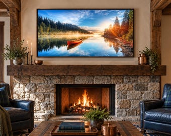 May include: A large rectangular television screen mounted above a stone fireplace displays a landscape image of a red canoe on a calm lake at sunrise. The fireplace features a thick wooden mantel, a burning fire, and two dark leather armchairs.
