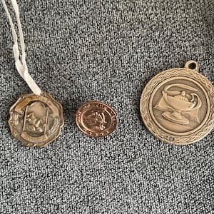 3 Vitage Medals YWCA 1940 10 mile champion dated and initialed plus 2 more.