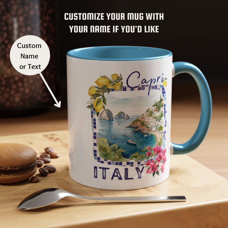 May include: White ceramic mug with a blue rim and handle. The mug features a watercolor illustration of the Italian island of Capri with the text "Capri" and "ITALY".