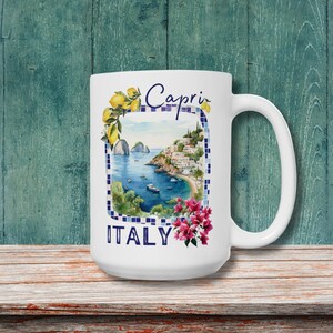 May include: White ceramic mug with a colorful illustration of a coastal town with the text "Capri ITALY" and lemons.