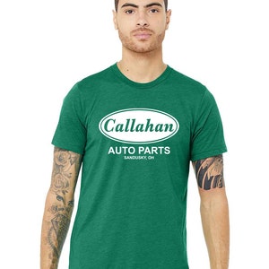 May include: A green t-shirt with a white oval logo that says "Callahan Auto Parts Sandusky, OH".