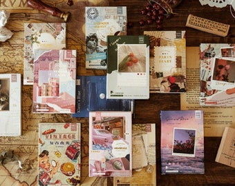 May include: A collection of vintage-style decorative paper journals with collage designs. The journals have titles such as "Vintage", "Baroque Poetry", and "Paris Diary".
