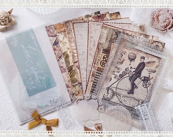 Könnte beinhalten: Eine Sammlung von Papier-Ephemera im Vintage-Stil mit Spitzenbesatz und dekorativen Elementen. Die Papiere zeigen florale, Steampunk- und Spitzenmuster in neutralen Farbtönen. Einige Papiere befinden sich in einer Klarsichttüte mit dem Text "Lace Cobalt".