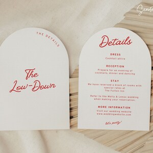 May include: Two white cards with rounded arches at the top. The card on the left has the text "The Low-Down" in red cursive. The card on the right has the text "Details" in red cursive. The card on the right also has the text "Dress, Cocktail attire, Reception, Prepare for an evening of cocktails, dinner and dancing, Stay, We have reserved a block of rooms with special rates at The Fulton Inn, Refer to the Molly & Lenox wedding when making your reservation, More Information, Visit our wedding website www.weddingwebsite.com, let's party!" in red text.
