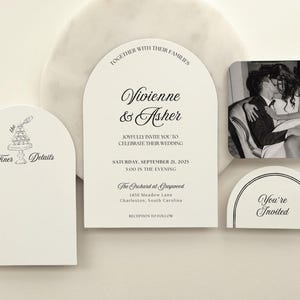 May include: A collection of wedding stationery, including an invitation with the names "Vivienne & Asher" and event details. Additional cards feature text like "Finer Details" and "You're Invited," along with a black and white photo.